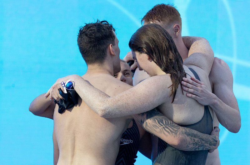 Mixed 4x100m Freestyle Relay team group hug Rome 2022